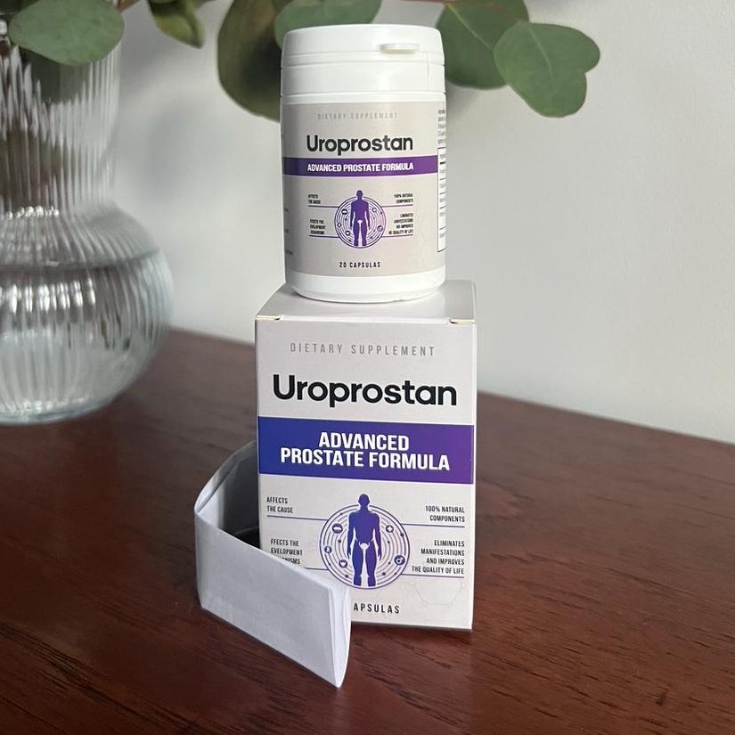 Frasco e caixa de Uroprostan, cápsulas para a próstata, em cima de um móvel